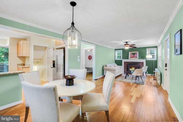 7906 Garland Ave, Takoma Park, MD 20912 - dining room with plenty of natural light, a fireplace, baseboards, ornamental molding, and light wood-style floors