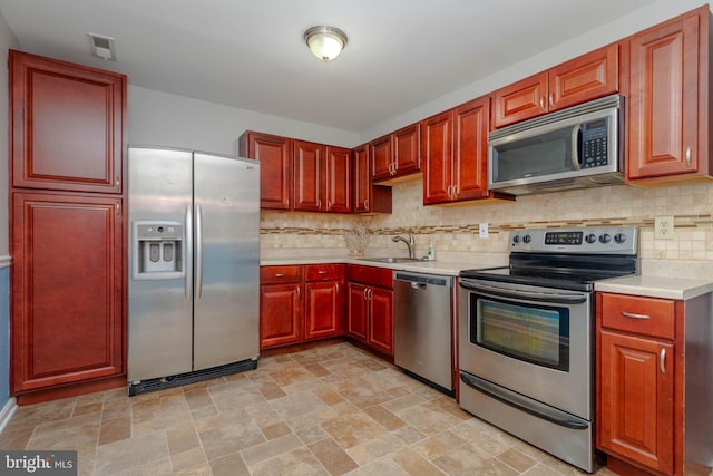 27 Holcumb Ct, Baltimore, MD 21220 - kitchen with appliances with stainless steel finishes, dark brown cabinets, a sink, and light countertops