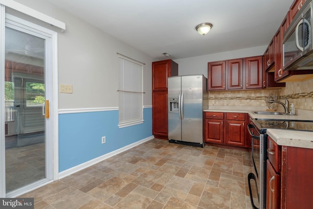 27 Holcumb Ct, Baltimore, MD 21220 - kitchen with stainless steel appliances, a sink, dark brown cabinets, and backsplash