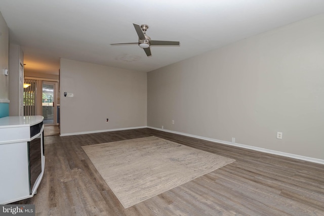 27 Holcumb Ct, Baltimore, MD 21220 - unfurnished living room with dark wood-style floors, a ceiling fan, and baseboards