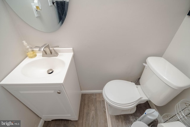 27 Holcumb Ct, Baltimore, MD 21220 - half bath featuring toilet, wood finished floors, vanity, and baseboards