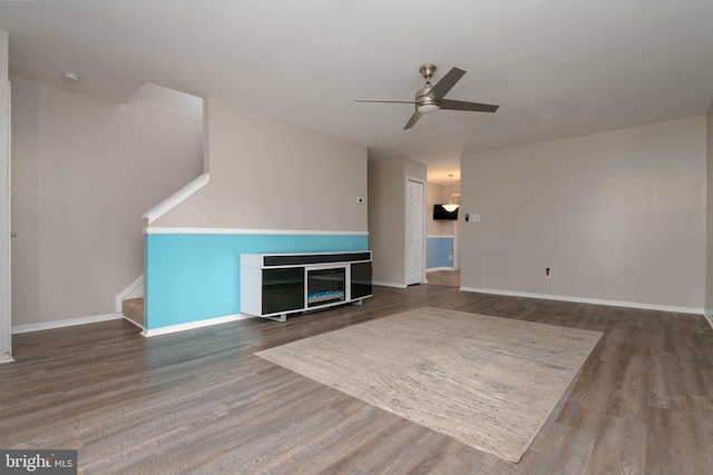 27 Holcumb Ct, Baltimore, MD 21220 - unfurnished living room with ceiling fan, wood finished floors, stairway, and baseboards