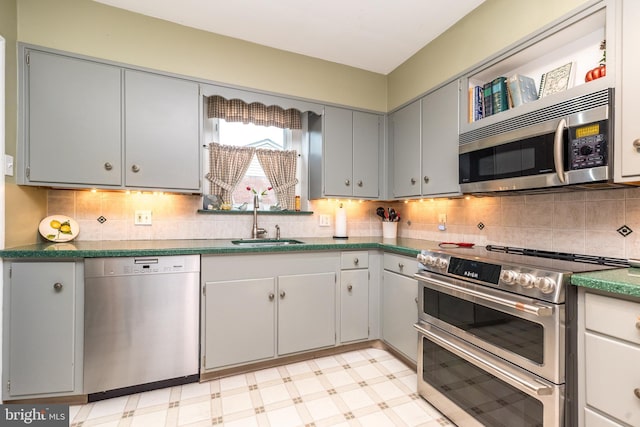 1431 Wheatsheaf Ln, Abington, PA 19001 - kitchen featuring appliances with stainless steel finishes, a sink, light floors, and decorative backsplash