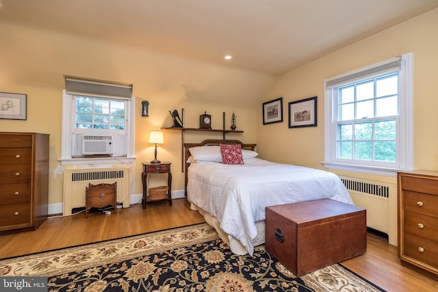 1431 Wheatsheaf Ln, Abington, PA 19001 - bedroom with radiator, wood finished floors, vaulted ceiling, and multiple windows
