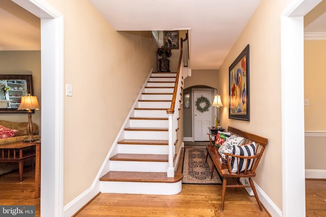 1431 Wheatsheaf Ln, Abington, PA 19001 - stairs with arched walkways, wood finished floors, and baseboards