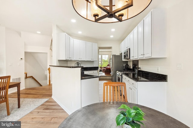 25366 Ashbury, Chantilly, VA 20152 - kitchen featuring dark countertops, light wood-style floors, white cabinets, and recessed lighting