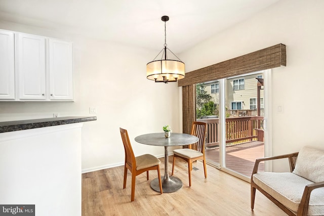 25366 Ashbury, Chantilly, VA 20152 - dining space with light wood-style flooring, a chandelier, and baseboards