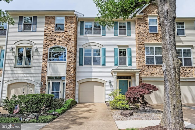 25366 Ashbury, Chantilly, VA 20152 - townhome / multi-family property with stone siding, concrete driveway, and a garage