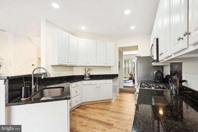 25366 Ashbury, Chantilly, VA 20152 - kitchen with appliances with stainless steel finishes, a sink, white cabinetry, light wood finished floors, and dark stone countertops