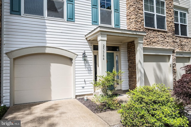 25366 Ashbury, Chantilly, VA 20152 - doorway to property featuring an attached garage, driveway, and stone siding