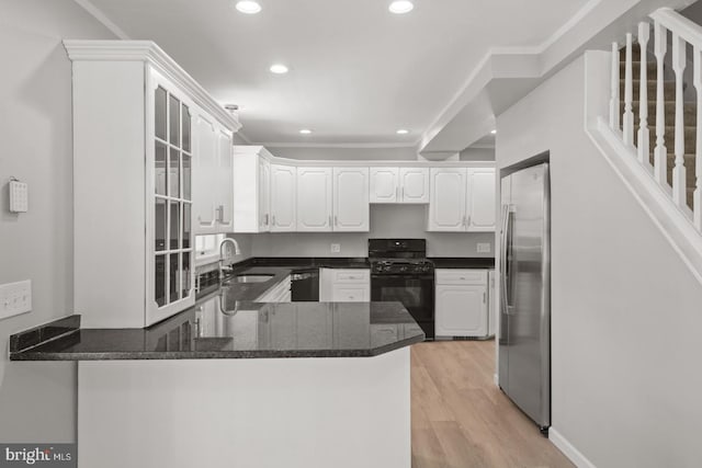 213 Redwood St, Harrisburg, PA 17109 - kitchen with black appliances, a sink, a peninsula, recessed lighting, and white cabinetry