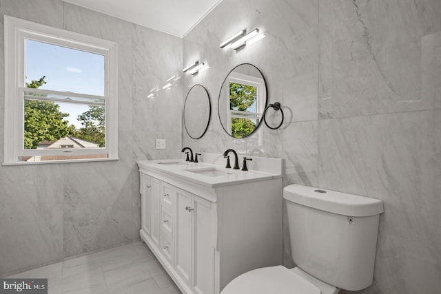 213 Redwood St, Harrisburg, PA 17109 - bathroom with tile walls, marble finish flooring, double vanity, plenty of natural light, and toilet