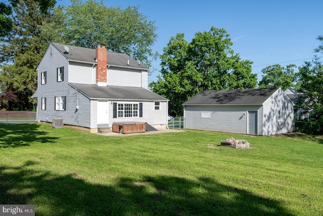 213 Redwood St, Harrisburg, PA 17109 - rear view of house with a hot tub, cooling unit, a chimney, a shingled roof, and an outdoor fire pit