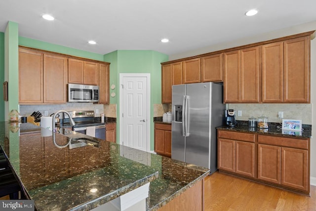 26360 Timbercreek Ln, Millsboro, DE 19966 - kitchen with appliances with stainless steel finishes, a sink, light wood-style flooring, brown cabinetry, and recessed lighting