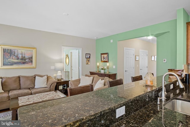 26360 Timbercreek Ln, Millsboro, DE 19966 - kitchen featuring a sink, open floor plan, and dark stone counters