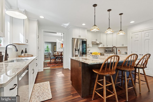 309 Conestoga Rd, Wayne, PA 19087 - kitchen featuring stainless steel appliances, a sink, dark wood-style floors, white cabinetry, and recessed lighting