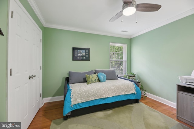 9410 Carleigh Ct, Owings, MD 20736 - bedroom featuring wood finished floors, ornamental molding, baseboards, a closet, and ceiling fan