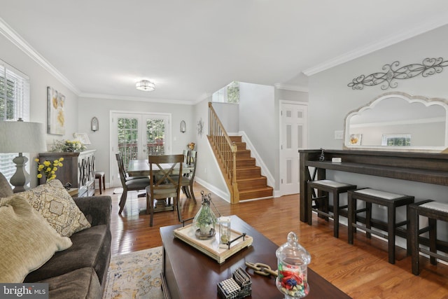 9410 Carleigh Ct, Owings, MD 20736 - living room featuring stairs, wood finished floors, ornamental molding, and baseboards