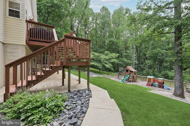 9410 Carleigh Ct, Owings, MD 20736 - view of grassy yard with a playground, a wooden deck, stairs, and a patio