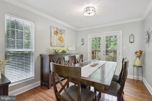 9410 Carleigh Ct, Owings, MD 20736 - dining room with healthy amount of natural light, crown molding, baseboards, and light wood-type flooring