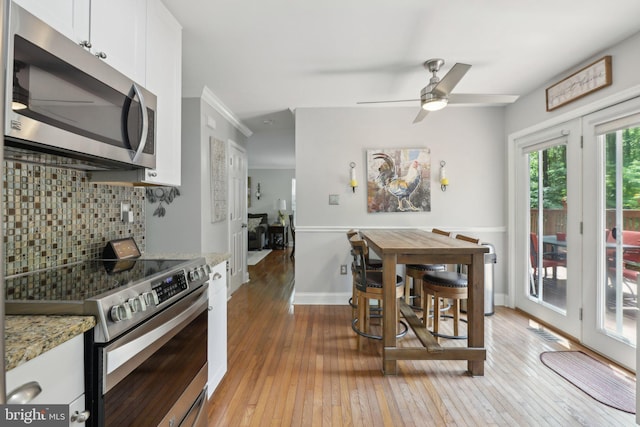 9410 Carleigh Ct, Owings, MD 20736 - dining area featuring light wood-style floors, a ceiling fan, and baseboards