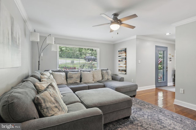 9410 Carleigh Ct, Owings, MD 20736 - living area featuring ceiling fan, healthy amount of natural light, wood finished floors, crown molding, and baseboards