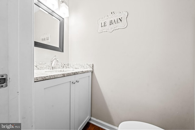 4047 Holly Way, Doylestown, PA 18902 - half bathroom with vanity, toilet, baseboards, and wood finished floors