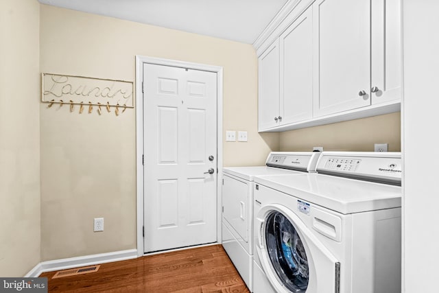 4047 Holly Way, Doylestown, PA 18902 - washroom featuring cabinet space, separate washer and dryer, wood finished floors, and baseboards