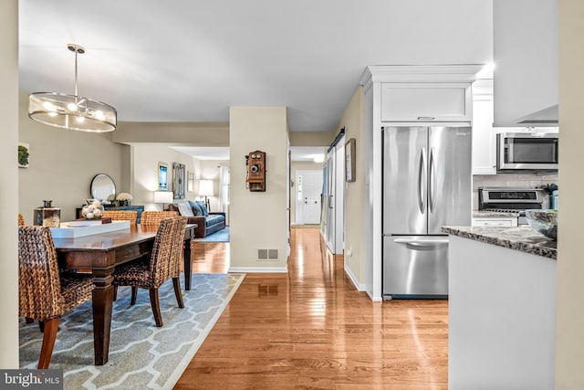 4047 Holly Way, Doylestown, PA 18902 - dining space with light wood-style flooring and a chandelier