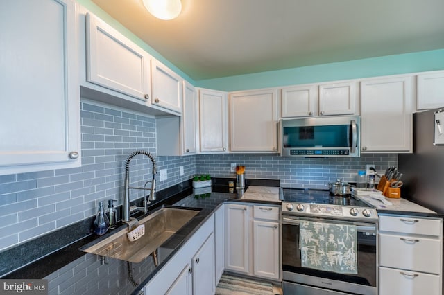 193 S Savanna Dr, Pottstown, PA 19465 - kitchen featuring stainless steel appliances, a sink, decorative backsplash, and dark stone counters
