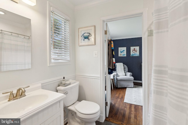 9212 E Parkhill Dr, Bethesda, MD 20814 - bathroom featuring crown molding, vanity, toilet, wood finished floors, and a wainscoted wall