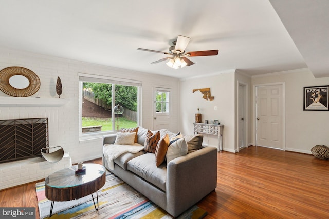 9212 E Parkhill Dr, Bethesda, MD 20814 - living area featuring wood finished floors, a ceiling fan, a fireplace, crown molding, and baseboards