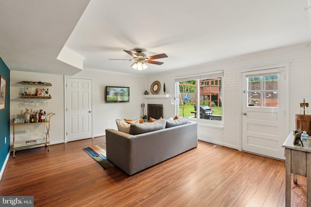 9212 E Parkhill Dr, Bethesda, MD 20814 - living area with wood finished floors, a ceiling fan, healthy amount of natural light, and a fireplace