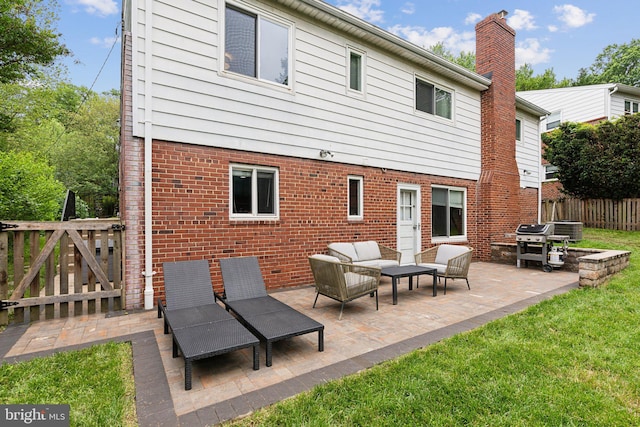 9212 E Parkhill Dr, Bethesda, MD 20814 - rear view of property with an outdoor hangout area, brick siding, central AC unit, a patio, and a chimney
