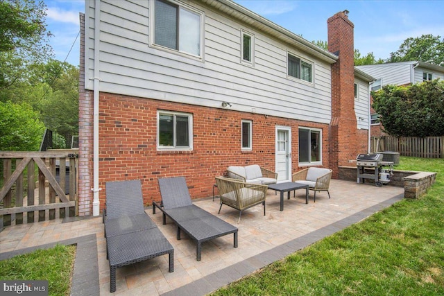 9212 E Parkhill Dr, Bethesda, MD 20814 - rear view of house with an outdoor hangout area, brick siding, a patio area, and a chimney