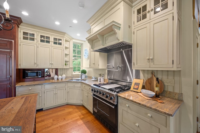 601 Maplewood Rd, Wayne, PA 19087 - kitchen featuring range with two ovens, stainless steel microwave, open shelves, tasteful backsplash, and light wood-type flooring