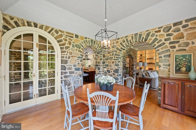 601 Maplewood Rd, Wayne, PA 19087 - dining space featuring arched walkways, a chandelier, light wood-style flooring, french doors, and wooden ceiling