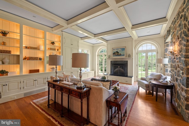 601 Maplewood Rd, Wayne, PA 19087 - living room featuring wood finished floors, a fireplace with raised hearth, beamed ceiling, coffered ceiling, and crown molding