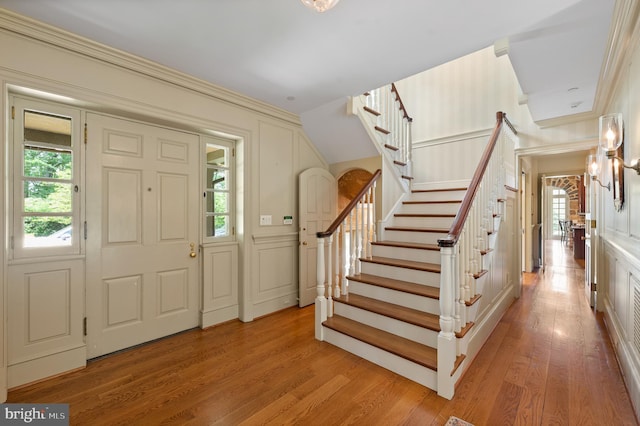 601 Maplewood Rd, Wayne, PA 19087 - foyer with stairway, light wood-type flooring, crown molding, and a decorative wall
