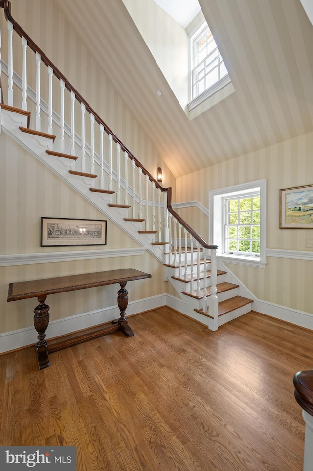 601 Maplewood Rd, Wayne, PA 19087 - staircase with wallpapered walls, wood finished floors, baseboards, and a skylight