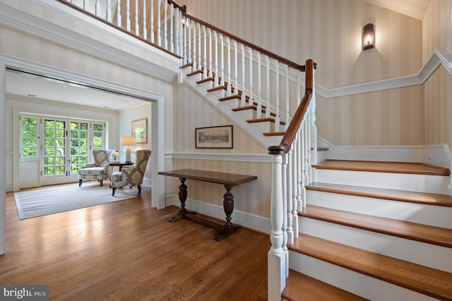601 Maplewood Rd, Wayne, PA 19087 - stairway with wallpapered walls, wood finished floors, baseboards, and ornamental molding