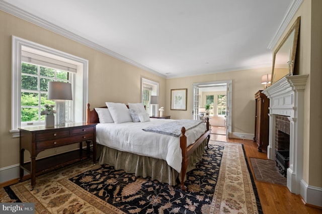 601 Maplewood Rd, Wayne, PA 19087 - bedroom with multiple windows, ornamental molding, wood finished floors, a fireplace, and baseboards