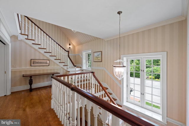 601 Maplewood Rd, Wayne, PA 19087 - stairs with a chandelier, wallpapered walls, wood finished floors, lofted ceiling, and ornamental molding