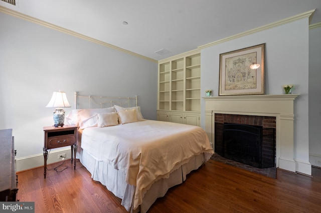 601 Maplewood Rd, Wayne, PA 19087 - bedroom with wood finished floors, crown molding, a brick fireplace, and baseboards