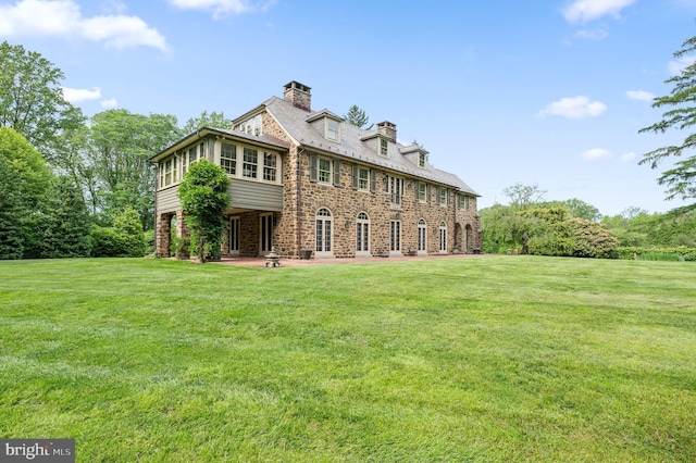 601 Maplewood Rd, Wayne, PA 19087 - back of property with a chimney, a lawn, a patio, and stone siding