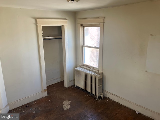 3505 24th St NE, Washington, DC 20018 - unfurnished bedroom featuring radiator, wood finished floors, and a closet