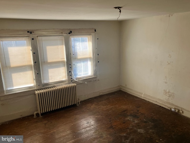 3505 24th St NE, Washington, DC 20018 - unfurnished room featuring radiator heating unit and wood-type flooring