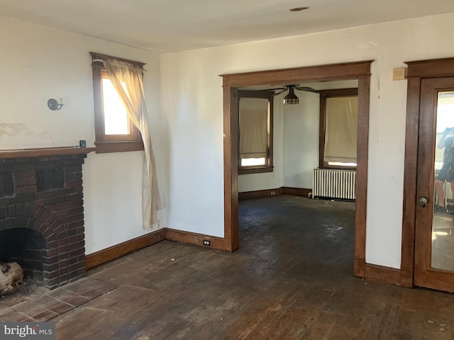 3505 24th St NE, Washington, DC 20018 - unfurnished living room with radiator, hardwood / wood-style floors, and plenty of natural light