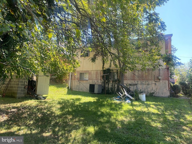 3240 Pope St SE, Washington, DC 20020 - view of green lawn featuring central air condition unit and an outdoor structure
