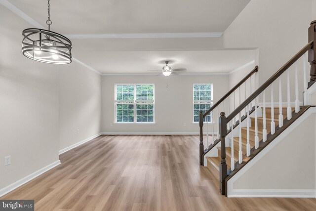 20524 Blue Heron Ter, Sterling, VA 20165 - unfurnished living room with light wood-type flooring, ornamental molding, stairway, and a ceiling fan